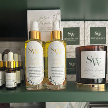 Load image into Gallery viewer, SW Botanicals products including bottles, a candle, and boxes on a shelf.